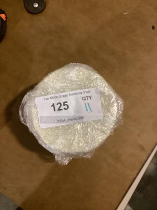 Set of 11 small scalloped dessert plates, 5-3/8 inches each, wrapped with auction tag showing item number 125.