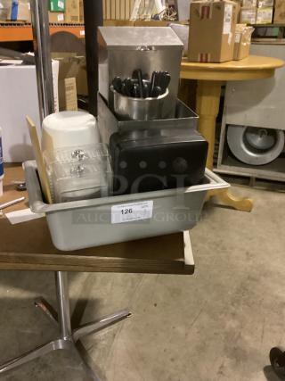 Assorted kitchen items in gray bin, includes utensils, metal holder, plastic containers. Auction label "126, QTY 1" visible.