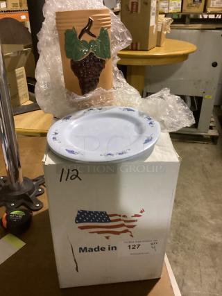 Miscellaneous kitchenware includes a ceramic vase with grape design and a round white plate with blue patterns on a box labeled "Made in USA."