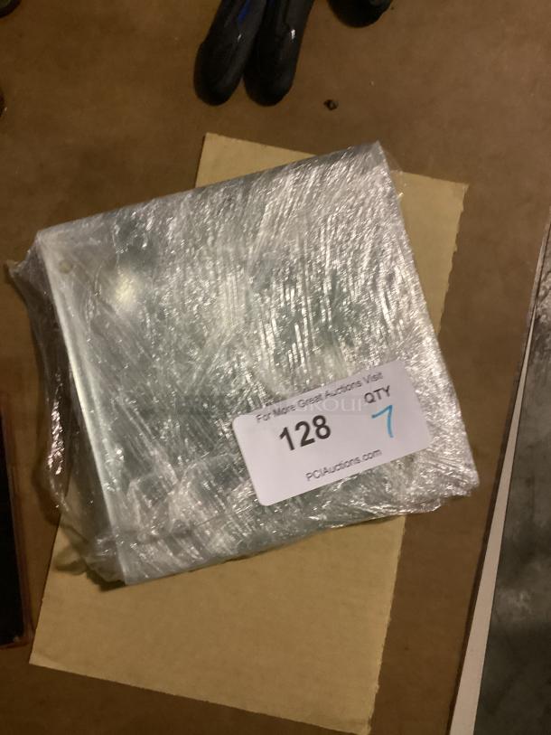 Clear glass 8-1/8" coasters, set of 7, wrapped in plastic. Auction label reads "128, QTY 7, PCAuctions.com."