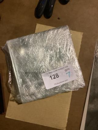 Clear glass 8-1/8" coasters, set of 7, wrapped in plastic. Auction label reads "128, QTY 7, PCAuctions.com."