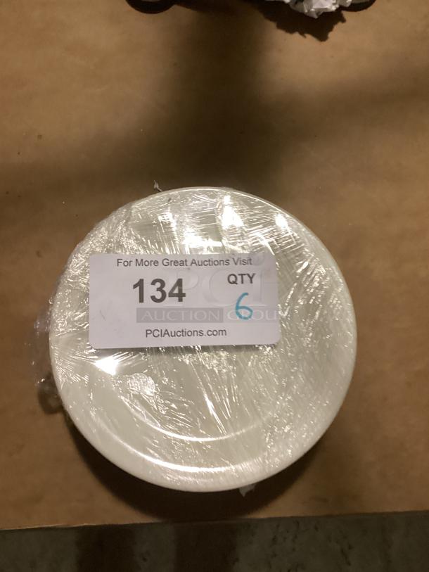 Set of six medium dessert plates, 6.5 inches, wrapped in plastic. Auction label reads "134, QTY 6, PCIAuctions.com".