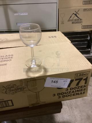 Clear red wine glass, 8-1/2" tall, on cardboard box marked "Napa Country," Libbey brand, auction lot 145.