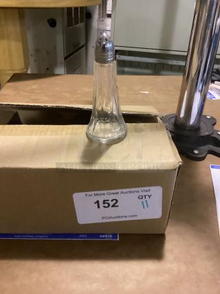 Small glass salt shaker with metal lid, 4-1/2" tall, on a cardboard box marked "152 QTY 11" from PCI Auctions.