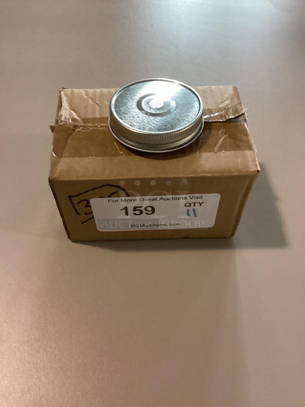 Small metal jar lids, 2-5/8 inch, qty 11, on box with auction label 159 from PCIAuctions.com.