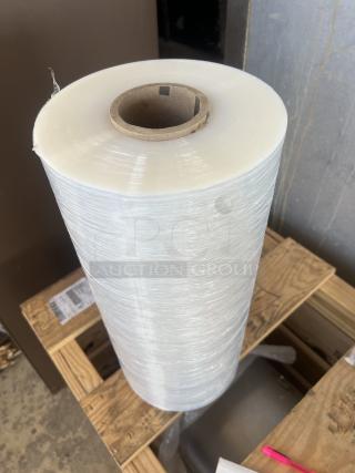 Large shrink wrap roll on wooden pallet; smooth surface; core visible; excellent condition; auction lot of 10.