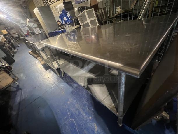 Stainless steel table, 72x30x39 inches, good condition, with lower shelf and sturdy legs, ideal for commercial use.