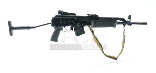 *Credit Card Transaction Only 🪪 - ATF Approved* ⚡️ FFL SHIP ONLY! ⚡️Collectors and firearms enthusiasts, attention!  RARE OPPORTUNITY! Hungarian AMP-69 7.62x39 Rifle! This is a Hungarian AMP-69 Grenade Launching Semi Auto AK type pre-89 rifle with the base being the AMD 63/65 platform built on a FEG SA 85M receiver by FEG / Kassnar Imports Inc. Typically these came in as Post Sample Machine guns by TGI of Tennessee however it is believed that these Semi Auto copies were imported directly by Kassnar before they went out of business in March 1989. All of the marked parts match the original serial number “KP 1801” as seen on the dust cover except for the scope and scope mount. The design was built specifically for grenade launch use with reciprocating forearm and collapsible, spring loaded butt stock, a special gas block with lever for modifying gas volume for grenade or rifle round use, a fully rifled barrel with a special muzzle extension attachment for redirecting gas to propel a grenade round, a special optic mounting rail and low power optic designed for launching grenades up to 400 meters. Must Ship to FFL, Check local laws regarding “Assault Weapons” BEFORE bidding. Pre 1989

Condition: This rifle is in Excellent condition and shows little to no signs of actual use. The bore is a mirror with crisp rifling. The stocks have some very minor marks from handling and the reciprocating components show a bit of finish loss due to standard wear. - Image 2 of 10