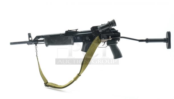 *Credit Card Transaction Only 🪪 - ATF Approved* ⚡️ FFL SHIP ONLY! ⚡️Collectors and firearms enthusiasts, attention!  RARE OPPORTUNITY! Hungarian AMP-69 7.62x39 Rifle! This is a Hungarian AMP-69 Grenade Launching Semi Auto AK type pre-89 rifle with the base being the AMD 63/65 platform built on a FEG SA 85M receiver by FEG / Kassnar Imports Inc. Typically these came in as Post Sample Machine guns by TGI of Tennessee however it is believed that these Semi Auto copies were imported directly by Kassnar before they went out of business in March 1989. All of the marked parts match the original serial number “KP 1801” as seen on the dust cover except for the scope and scope mount. The design was built specifically for grenade launch use with reciprocating forearm and collapsible, spring loaded butt stock, a special gas block with lever for modifying gas volume for grenade or rifle round use, a fully rifled barrel with a special muzzle extension attachment for redirecting gas to propel a grenade round, a special optic mounting rail and low power optic designed for launching grenades up to 400 meters. Must Ship to FFL, Check local laws regarding “Assault Weapons” BEFORE bidding. Pre 1989

Condition: This rifle is in Excellent condition and shows little to no signs of actual use. The bore is a mirror with crisp rifling. The stocks have some very minor marks from handling and the reciprocating components show a bit of finish loss due to standard wear. - Image 4 of 10