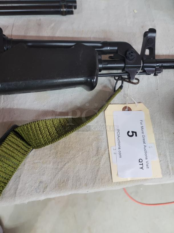 *Credit Card Transaction Only 🪪 - ATF Approved* ⚡️ FFL SHIP ONLY! ⚡️Collectors and firearms enthusiasts, attention!  RARE OPPORTUNITY! Hungarian AMP-69 7.62x39 Rifle! This is a Hungarian AMP-69 Grenade Launching Semi Auto AK type pre-89 rifle with the base being the AMD 63/65 platform built on a FEG SA 85M receiver by FEG / Kassnar Imports Inc. Typically these came in as Post Sample Machine guns by TGI of Tennessee however it is believed that these Semi Auto copies were imported directly by Kassnar before they went out of business in March 1989. All of the marked parts match the original serial number “KP 1801” as seen on the dust cover except for the scope and scope mount. The design was built specifically for grenade launch use with reciprocating forearm and collapsible, spring loaded butt stock, a special gas block with lever for modifying gas volume for grenade or rifle round use, a fully rifled barrel with a special muzzle extension attachment for redirecting gas to propel a grenade round, a special optic mounting rail and low power optic designed for launching grenades up to 400 meters. Must Ship to FFL, Check local laws regarding “Assault Weapons” BEFORE bidding. Pre 1989

Condition: This rifle is in Excellent condition and shows little to no signs of actual use. The bore is a mirror with crisp rifling. The stocks have some very minor marks from handling and the reciprocating components show a bit of finish loss due to standard wear. - Image 7 of 10