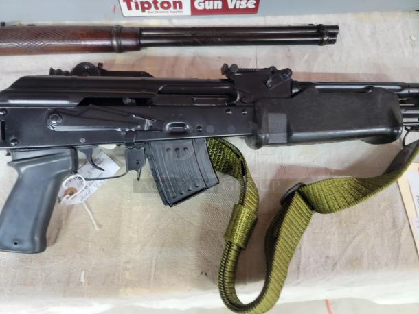 *Credit Card Transaction Only 🪪 - ATF Approved* ⚡️ FFL SHIP ONLY! ⚡️Collectors and firearms enthusiasts, attention!  RARE OPPORTUNITY! Hungarian AMP-69 7.62x39 Rifle! This is a Hungarian AMP-69 Grenade Launching Semi Auto AK type pre-89 rifle with the base being the AMD 63/65 platform built on a FEG SA 85M receiver by FEG / Kassnar Imports Inc. Typically these came in as Post Sample Machine guns by TGI of Tennessee however it is believed that these Semi Auto copies were imported directly by Kassnar before they went out of business in March 1989. All of the marked parts match the original serial number “KP 1801” as seen on the dust cover except for the scope and scope mount. The design was built specifically for grenade launch use with reciprocating forearm and collapsible, spring loaded butt stock, a special gas block with lever for modifying gas volume for grenade or rifle round use, a fully rifled barrel with a special muzzle extension attachment for redirecting gas to propel a grenade round, a special optic mounting rail and low power optic designed for launching grenades up to 400 meters. Must Ship to FFL, Check local laws regarding “Assault Weapons” BEFORE bidding. Pre 1989

Condition: This rifle is in Excellent condition and shows little to no signs of actual use. The bore is a mirror with crisp rifling. The stocks have some very minor marks from handling and the reciprocating components show a bit of finish loss due to standard wear. - Image 8 of 10