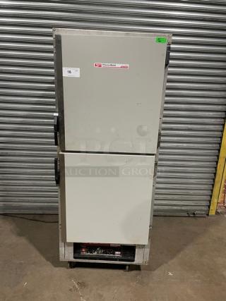 Traulsen double-door commercial refrigerator, model TBC, in good condition. Visible Traulsen label and auction number 16 tag.