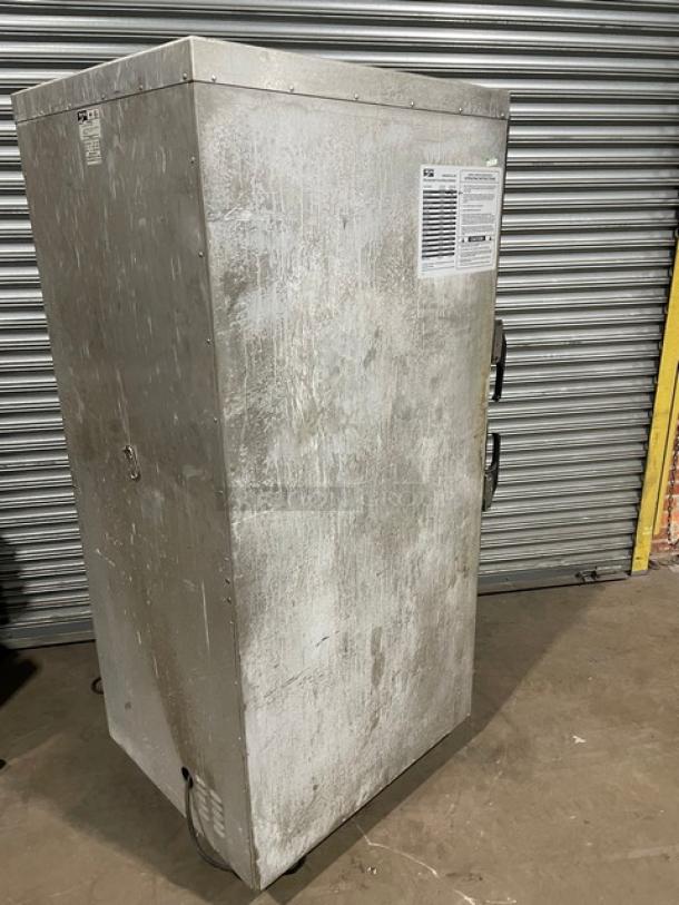 Industrial metal storage cabinet with visible scuffs and wear. Two handles, locking mechanism, and information label on the door.