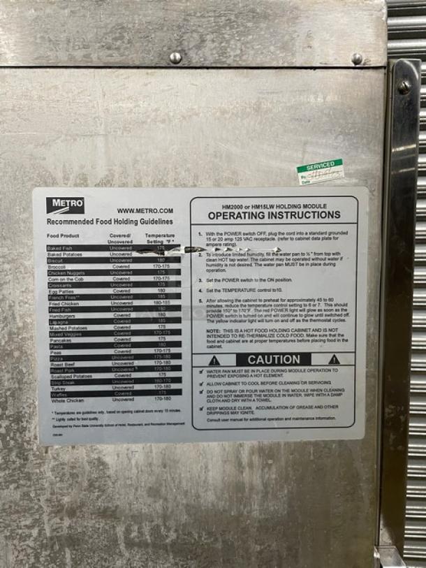 Metro holding module with operating instructions and food holding guidelines, stainless steel, service tag visible.