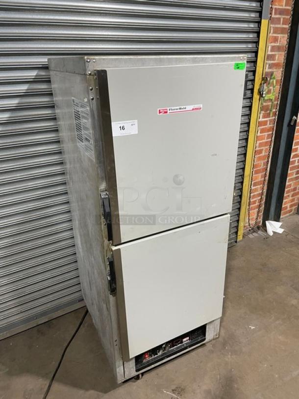 Traulsen commercial refrigerator, model AHT132WUT-HHS, stainless steel, dual-door, fair condition with visible wear, auction tag 16.
