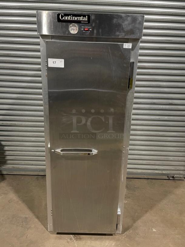 Commercial stainless steel refrigerator by Continental, model unclear, with visible temperature gauge and label "17." Good condition.