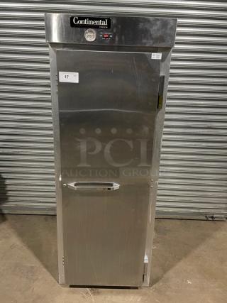Commercial stainless steel refrigerator by Continental, model unclear, with visible temperature gauge and label "17." Good condition.