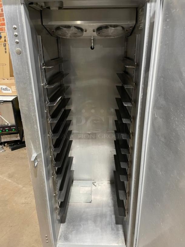 Stainless steel commercial warming cabinet with multiple shelves, front door ajar, showing interior and fans, in good condition.