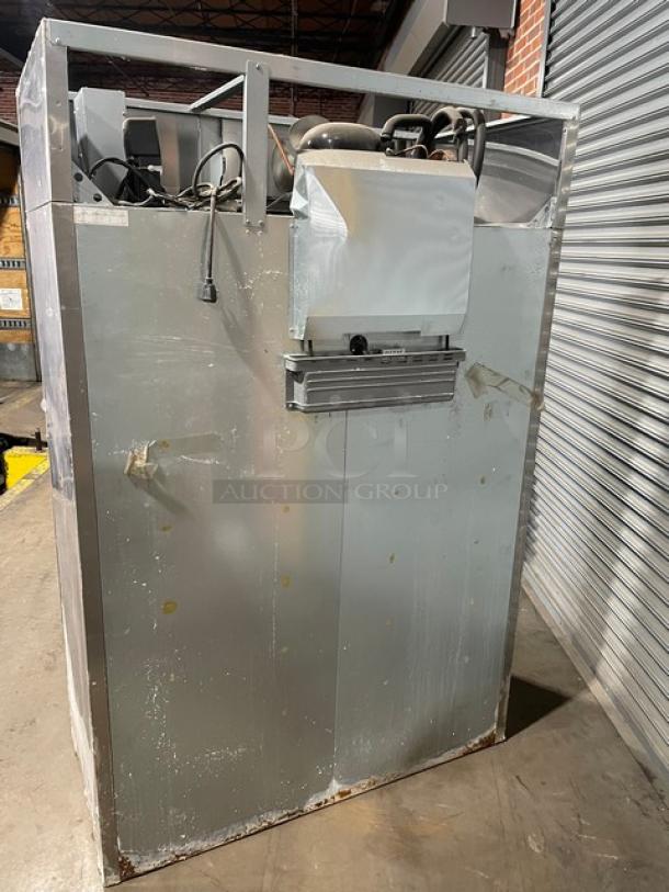 Commercial industrial freezer unit, metallic finish, used condition, visible electrical components, some surface rust, auction item.