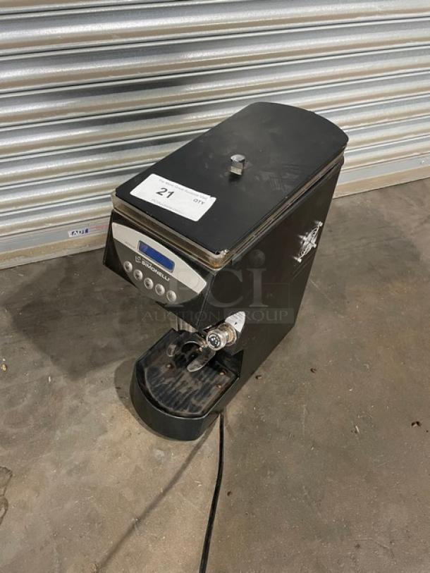 Black espresso machine with digital controls and spout. Visible wear. Label reads "U3 SPROUTING." Auction tag "21."