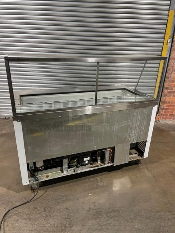 Stainless steel commercial display refrigerator, glass top, visible wear, working condition, dimensions approx. 6ft x 3ft.