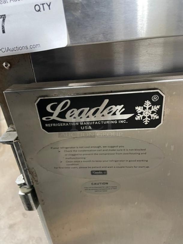 Leader commercial refrigerator door with logo and maintenance instructions, indicating USA-made quality.