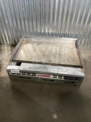Commercial griddle from American Range, used, with visible rust and wear. Model label in front. Lot number 15.