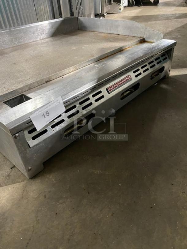 Commercial griddle by American Range in fair condition, showing metal surface and vents. Tag marked "15" indicates auction lot number.