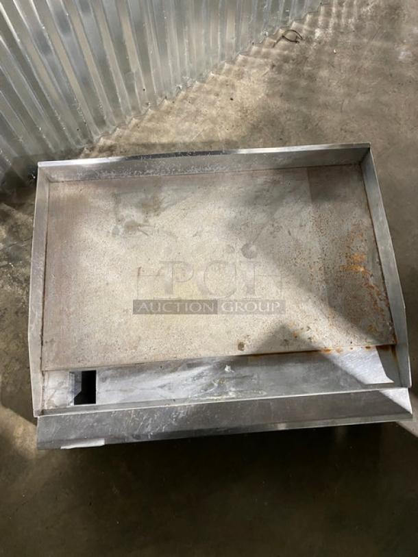 Metal baking tray with raised edges, shows signs of rust and wear, suitable for restoration or decor use.