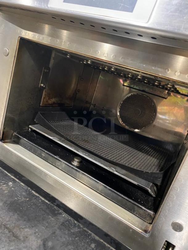 Commercial stainless steel oven interior, used condition, with visible grill tray and vent, suited for high-volume cooking.