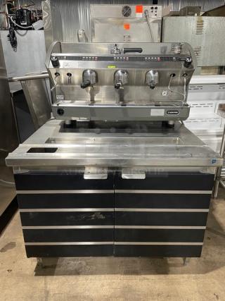 Azkoyen Commercial Electric Powered Countertop 3-Group Automatic Espresso Machine! With Steam Wand & Drip Tray! On Coffee Station/Equipment Stand! With Built In Drain Board & Enclosed 2 Door Underneath Cabinet! Model: AZ04/M! 208/220V 1 Phase! On Legs! - Item #1189121