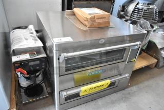 Stainless steel Turbochef oven in good condition, double doors with caution label. Includes a Bunn coffee brewer.