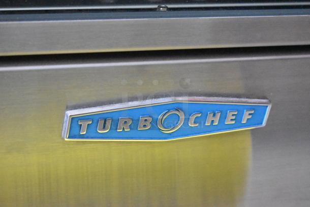 TurboChef commercial oven, close-up of logo, stainless steel finish, in good condition. Ideal for quick cooking.