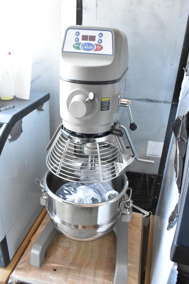 Globe commercial mixer with control panel, stainless steel bowl, and wire guard. Condition: Appears new, accessories included.