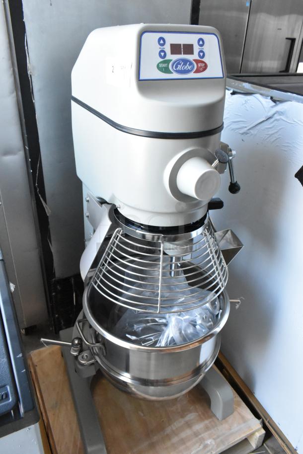 Globe commercial mixer with digital controls, large stainless steel bowl, and safety guard. Appears in good condition.
