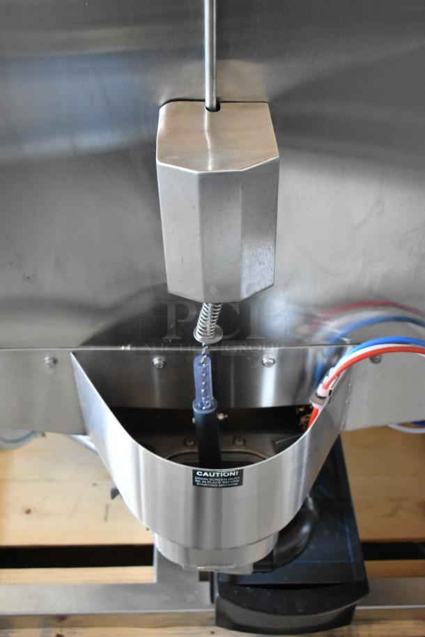 Stainless steel industrial machine part with wiring, featuring a caution label. Used condition. Key component visible.