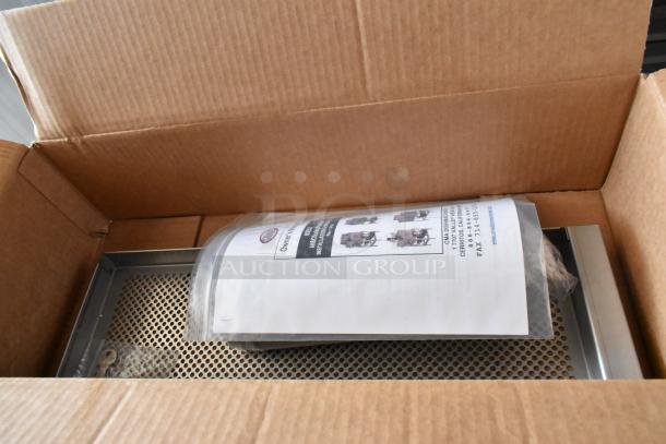 Industrial stainless steel filter in a cardboard box with user manual and installation instructions, new condition.