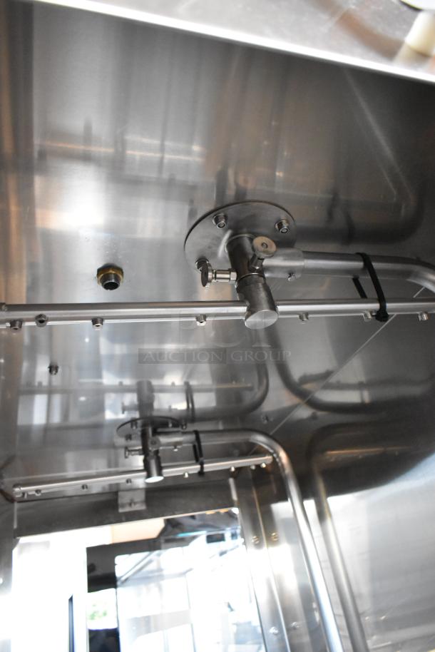 Stainless steel industrial piping system with valves and joints, in excellent condition, suitable for processing equipment.