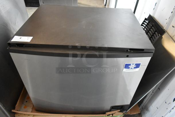 Manitowoc ice machine, stainless steel, with visible logo, in used condition. Auction label on top indicates item details.