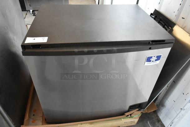 Manitowoc ice machine in good condition, stainless steel exterior, visible label on front indicating brand.
