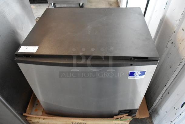 Stainless steel Manitowoc ice maker in good condition, Model ID0322A, with visible label indicating commercial use.