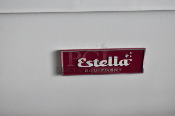 Estella Equipment label on white surface, red and silver design, indicates brand identity, pristine condition.