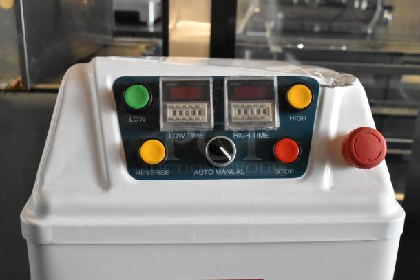 White control panel with "Hua Tong Ji Dian" timers, low/high settings, reverse, stop, red emergency button, slight wear.