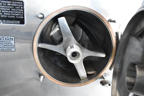 Industrial stainless steel mixing chamber with visible blades and caution labels about moving parts, in good condition.