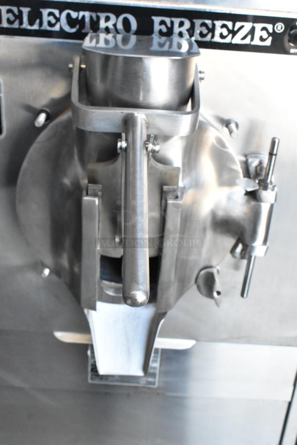 Stainless steel Electro Freeze ice cream machine in good condition, featuring a dispensing lever and branded markings.