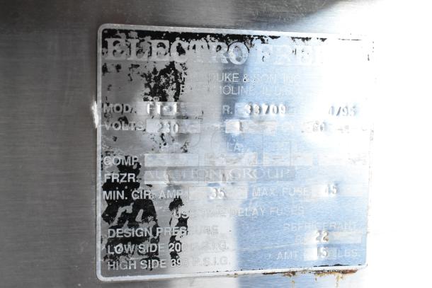 Metal plate with faded text showing model F1, serial 33709, voltage 230, made by HC Duke & Son, Inc.