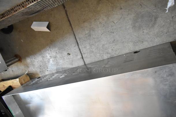 Stainless steel rectangular wall panel with perforations, in good condition, suitable for industrial use.