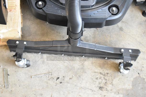 Industrial floor squeegee attachment with caster wheels, black, in excellent condition, for heavy-duty cleaning equipment.