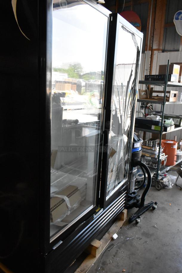 Commercial display refrigerator with cracked glass door, visible shelving inside. Unit shows signs of damage, needs repair.