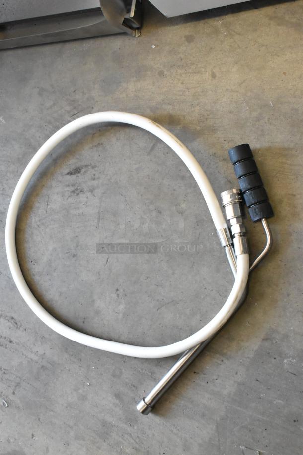 White coiled hose with a metal nozzle and black rubber grip, suitable for pneumatic use, in good condition.